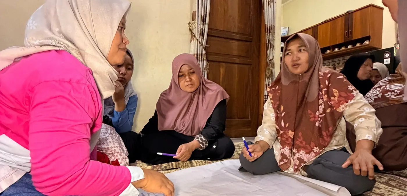 Perempuan pengolah gula kelapa berdiskusi dalam lingkaran